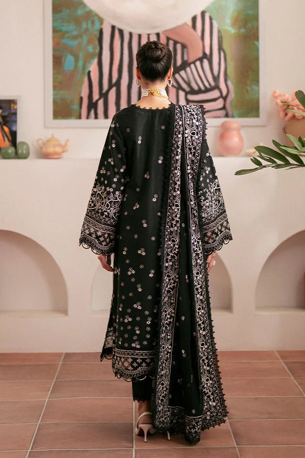 Model wearing black Ebony dress from Saffron, featuring intricate embroidery. Ideal for Pakistani designer clothes in the UK, readymade clothes, and festive lawn collections.