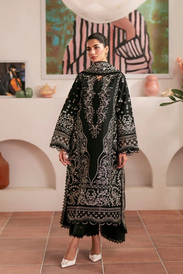 Model wearing black Ebony dress from Saffron, featuring intricate embroidery. Ideal for Pakistani designer clothes in the UK, readymade clothes, and festive lawn collections.