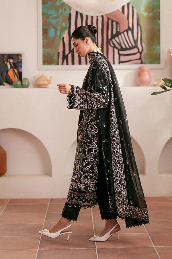 Model wearing black Ebony dress from Saffron, featuring intricate embroidery. Ideal for Pakistani designer clothes in the UK, readymade clothes, and festive lawn collections.