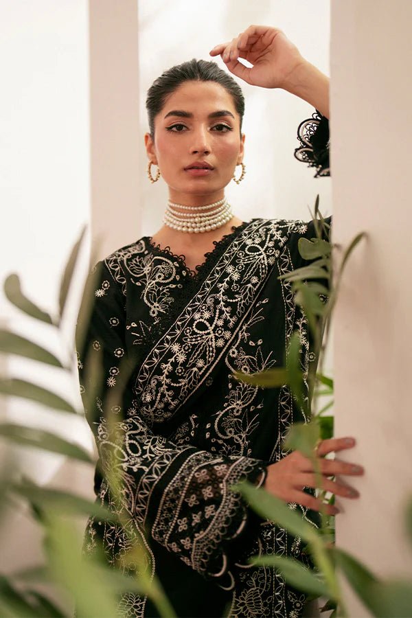 Model wearing black Ebony dress from Saffron, featuring intricate embroidery. Ideal for Pakistani designer clothes in the UK, readymade clothes, and festive lawn collections.