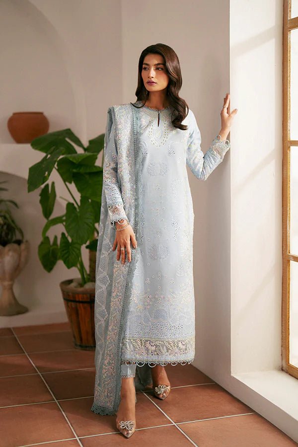 Model wearing light blue Kye dress from Saffron, showcasing Pakistani designer clothes in the UK. Ideal for festive lawn collections and readymade clothing.