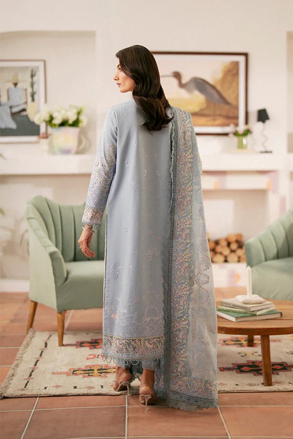 Model wearing light blue Kye dress from Saffron, showcasing Pakistani designer clothes in the UK. Ideal for festive lawn collections and readymade clothing.