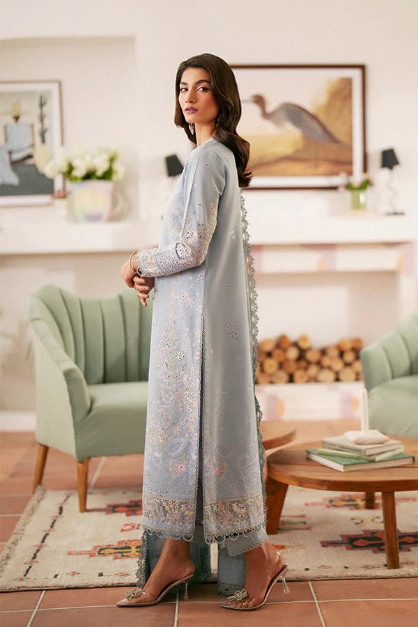 Model wearing light blue Kye dress from Saffron, showcasing Pakistani designer clothes in the UK. Ideal for festive lawn collections and readymade clothing.