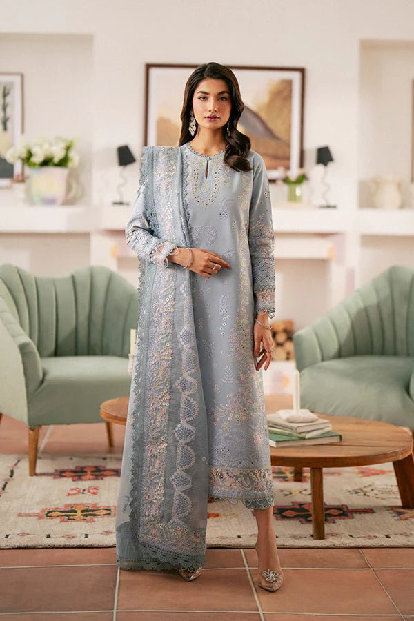 Model wearing light blue Kye dress from Saffron, showcasing Pakistani designer clothes in the UK. Ideal for festive lawn collections and readymade clothing.