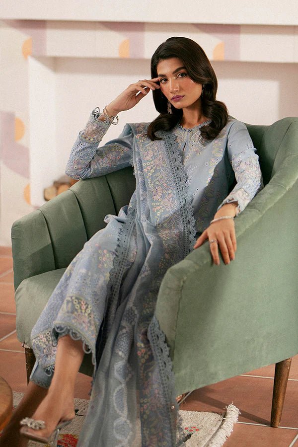 Model wearing light blue Kye dress from Saffron, showcasing Pakistani designer clothes in the UK. Ideal for festive lawn collections and readymade clothing.