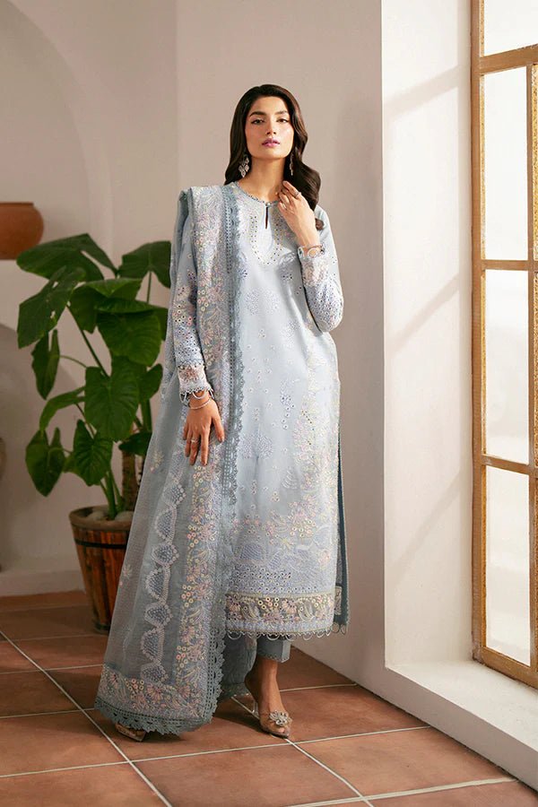 Model wearing light blue Kye dress from Saffron, showcasing Pakistani designer clothes in the UK. Ideal for festive lawn collections and readymade clothing.