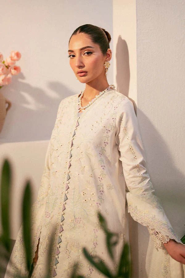 Model wearing white Liara dress from Saffron, featuring delicate embroidery. Ideal for Pakistani designer clothes in the UK, readymade clothes, and festive lawn collections.