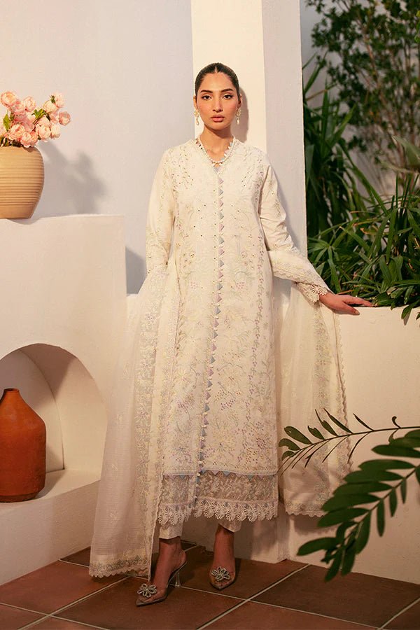 Model wearing white Liara dress from Saffron, featuring delicate embroidery. Ideal for Pakistani designer clothes in the UK, readymade clothes, and festive lawn collections.