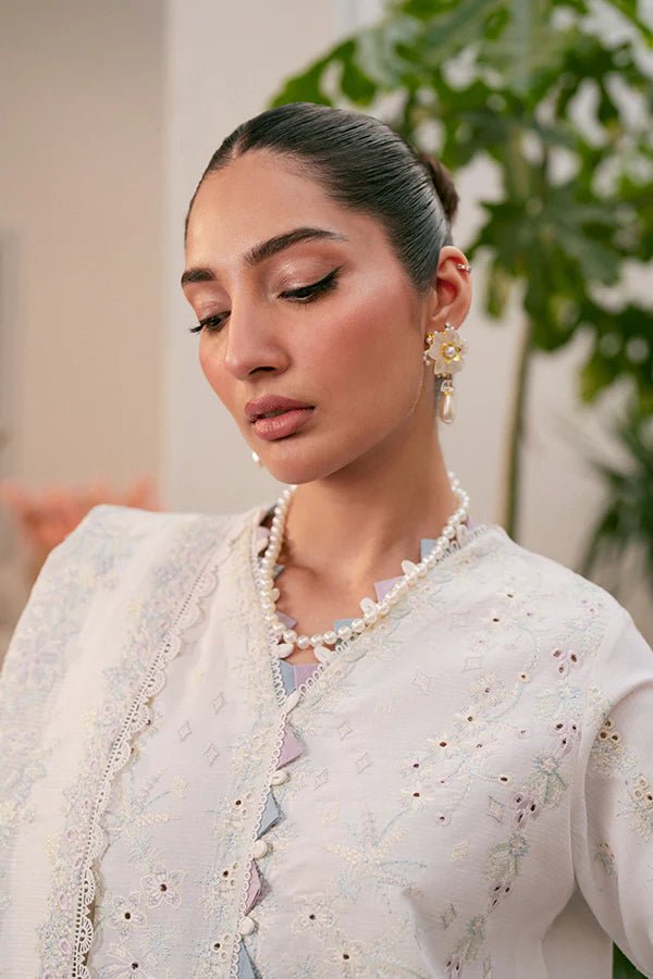 Model wearing white Liara dress from Saffron, featuring delicate embroidery. Ideal for Pakistani designer clothes in the UK, readymade clothes, and festive lawn collections.