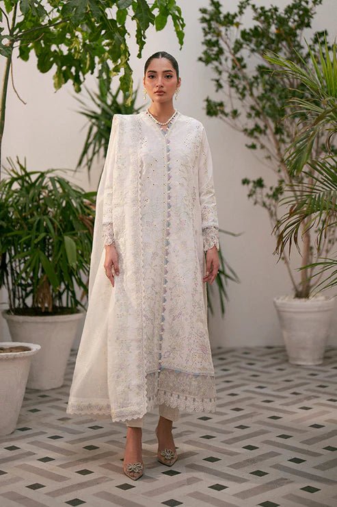 Model wearing white Liara dress from Saffron, featuring delicate embroidery. Ideal for Pakistani designer clothes in the UK, readymade clothes, and festive lawn collections.