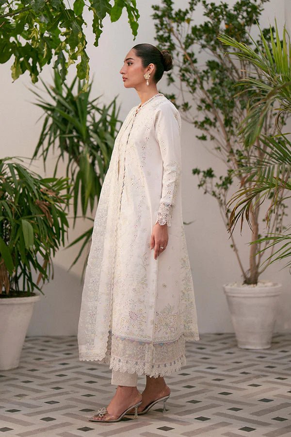 Model wearing white Liara dress from Saffron, featuring delicate embroidery. Ideal for Pakistani designer clothes in the UK, readymade clothes, and festive lawn collections.