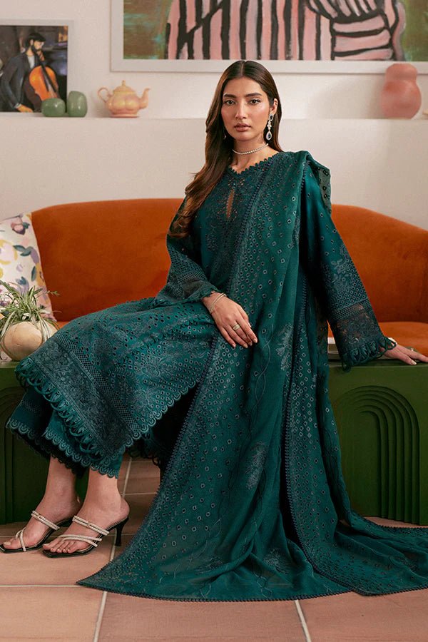 Model wearing deep green Raya dress from Saffron, highlighting Pakistani designer clothes in the UK. Perfect for festive lawn collections and readymade clothing.