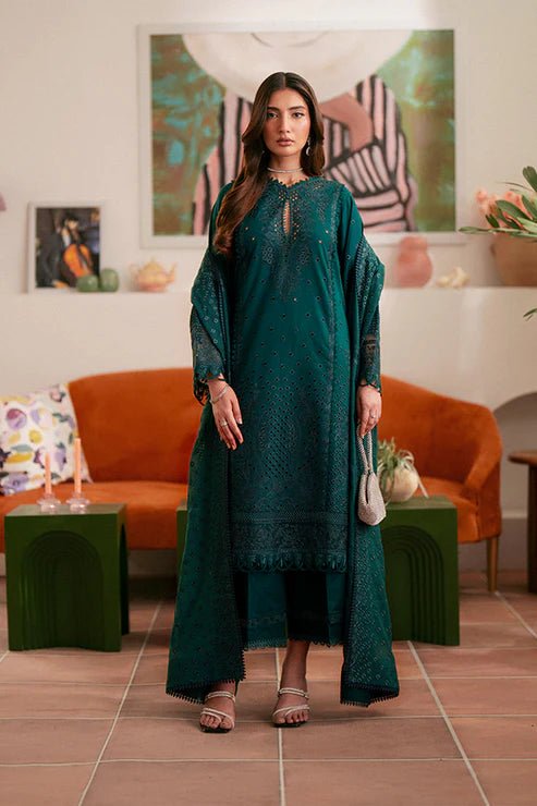 Model wearing deep green Raya dress from Saffron, highlighting Pakistani designer clothes in the UK. Perfect for festive lawn collections and readymade clothing.