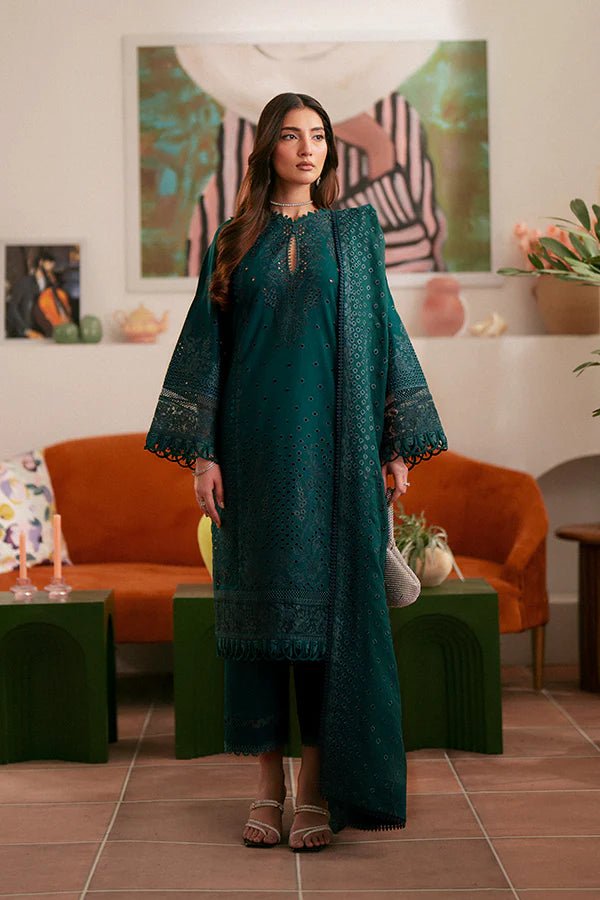 Model wearing deep green Raya dress from Saffron, highlighting Pakistani designer clothes in the UK. Perfect for festive lawn collections and readymade clothing.