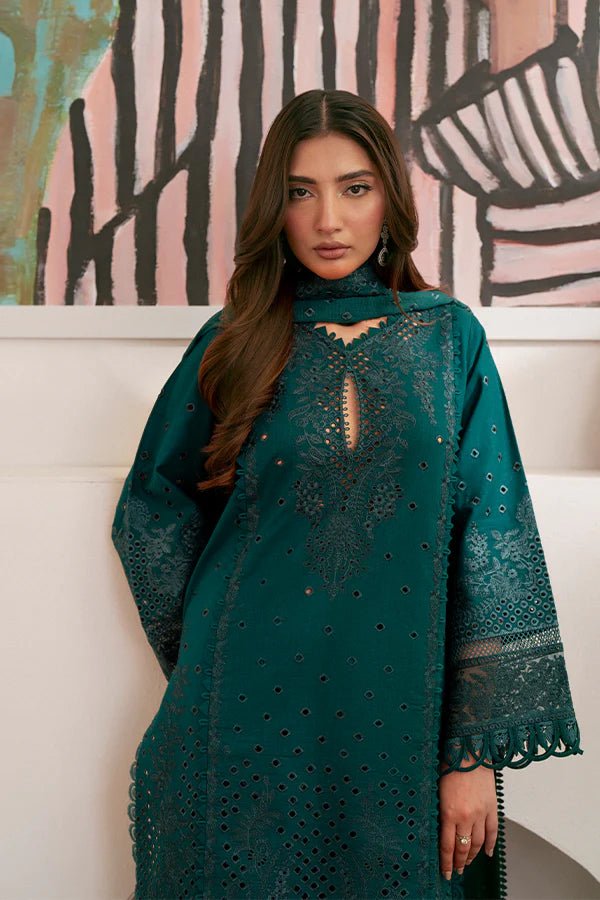 Model wearing deep green Raya dress from Saffron, highlighting Pakistani designer clothes in the UK. Perfect for festive lawn collections and readymade clothing.