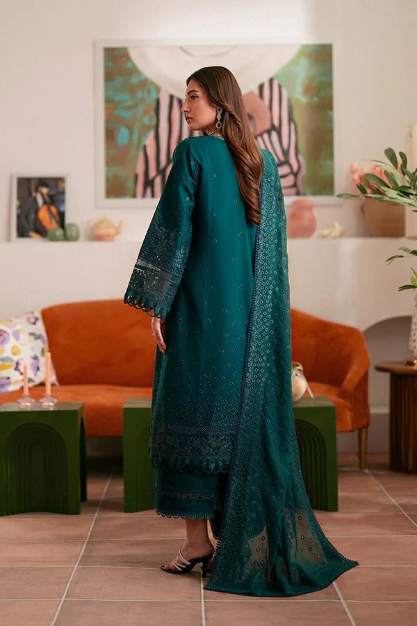 Model wearing deep green Raya dress from Saffron, highlighting Pakistani designer clothes in the UK. Perfect for festive lawn collections and readymade clothing.