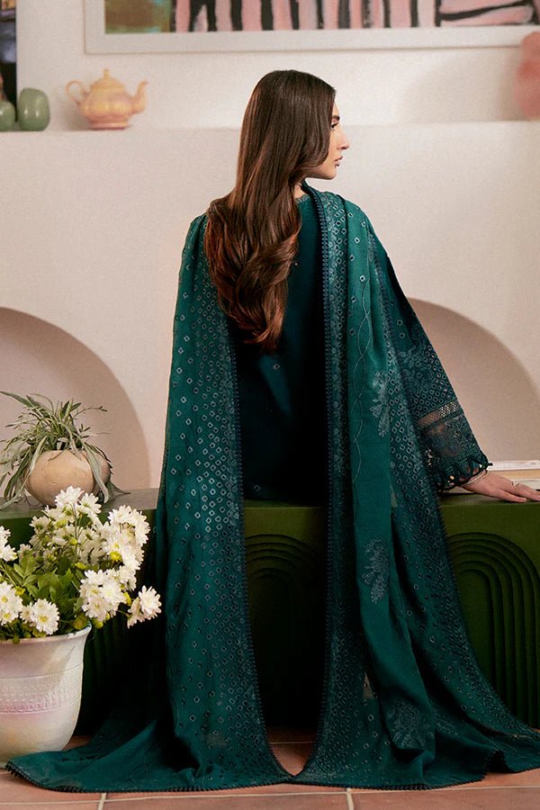 Model wearing deep green Raya dress from Saffron, highlighting Pakistani designer clothes in the UK. Perfect for festive lawn collections and readymade clothing.