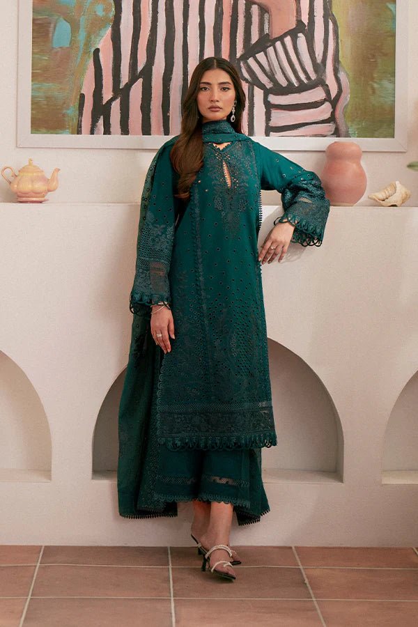 Model wearing deep green Raya dress from Saffron, highlighting Pakistani designer clothes in the UK. Perfect for festive lawn collections and readymade clothing.