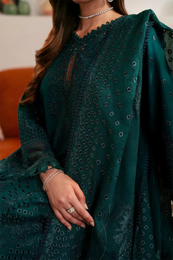 Model wearing deep green Raya dress from Saffron, highlighting Pakistani designer clothes in the UK. Perfect for festive lawn collections and readymade clothing.