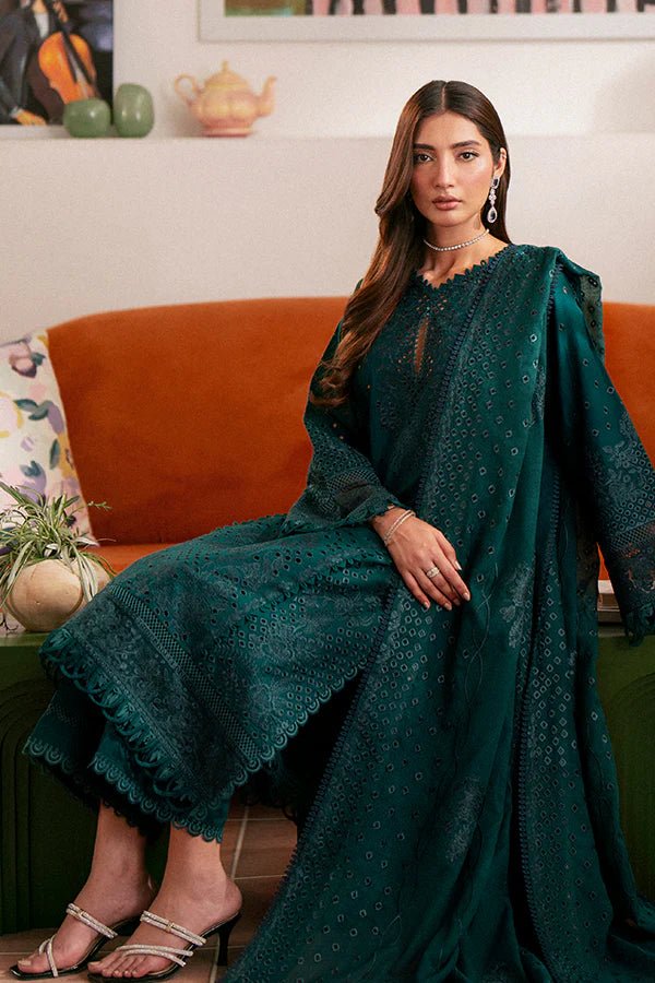 Model wearing deep green Raya dress from Saffron, highlighting Pakistani designer clothes in the UK. Perfect for festive lawn collections and readymade clothing.