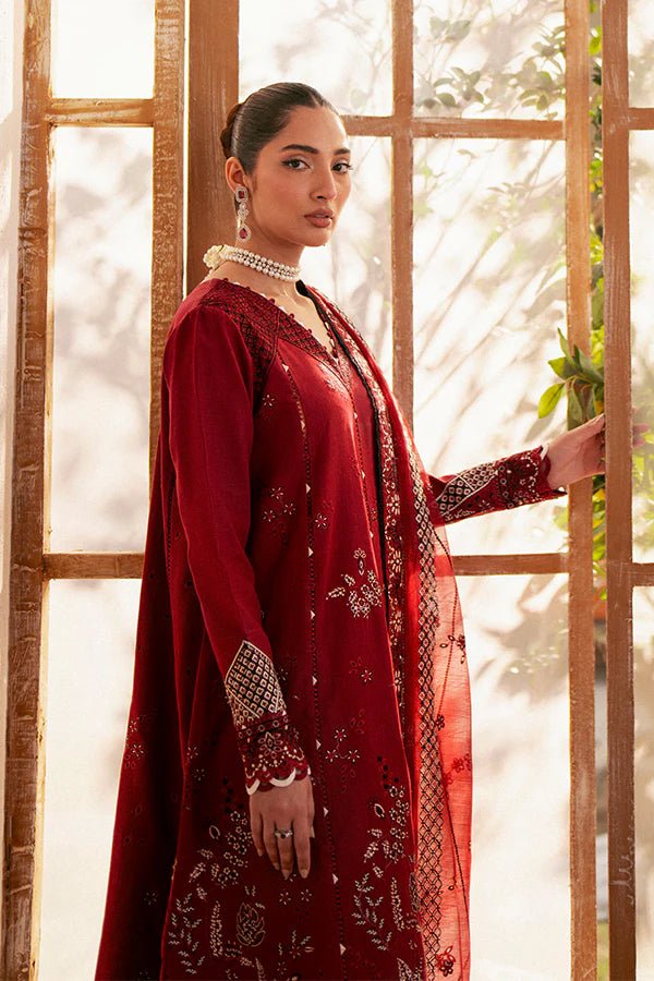 Model wearing deep red Selah dress from Saffron, showcasing Pakistani designer clothes in the UK. Ideal for festive lawn collections and readymade clothing.