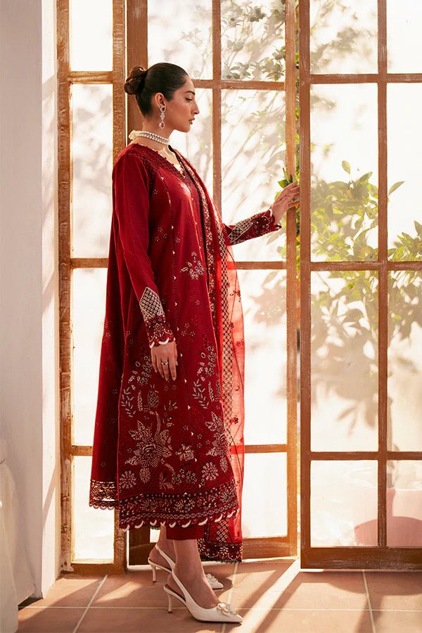 Model wearing deep red Selah dress from Saffron, showcasing Pakistani designer clothes in the UK. Ideal for festive lawn collections and readymade clothing.