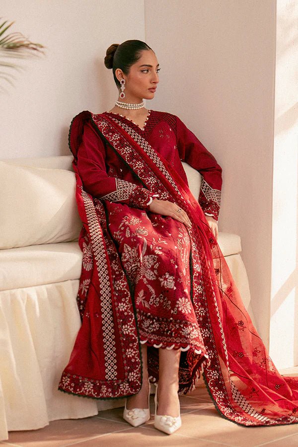 Model wearing deep red Selah dress from Saffron, showcasing Pakistani designer clothes in the UK. Ideal for festive lawn collections and readymade clothing.