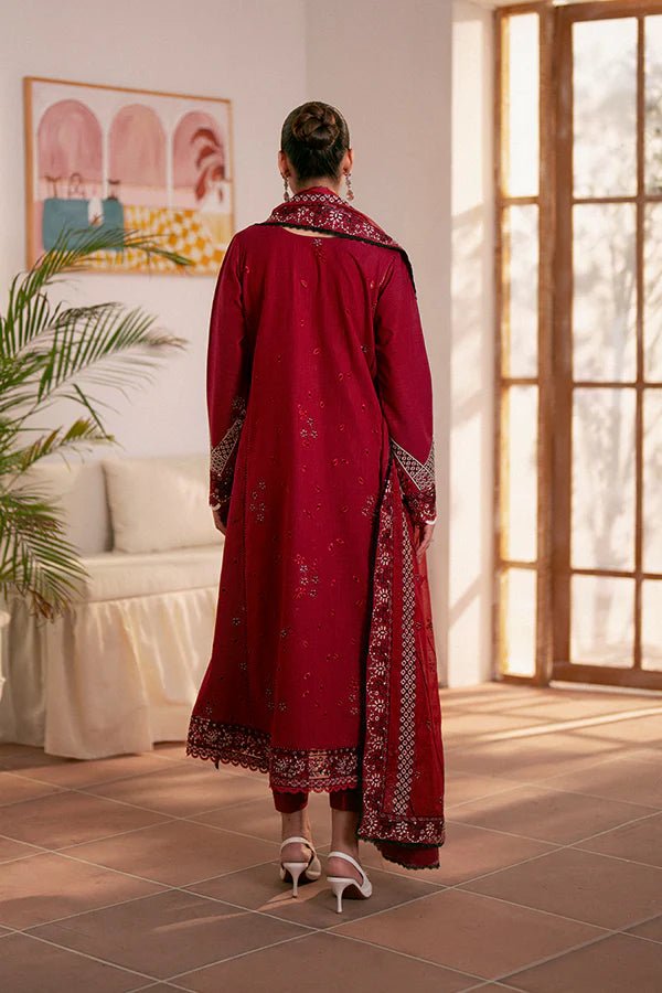 Model wearing deep red Selah dress from Saffron, showcasing Pakistani designer clothes in the UK. Ideal for festive lawn collections and readymade clothing.