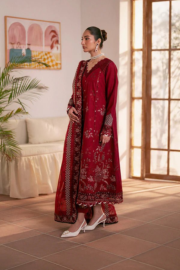 Model wearing deep red Selah dress from Saffron, showcasing Pakistani designer clothes in the UK. Ideal for festive lawn collections and readymade clothing.