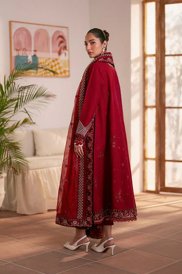 Model wearing deep red Selah dress from Saffron, showcasing Pakistani designer clothes in the UK. Ideal for festive lawn collections and readymade clothing.