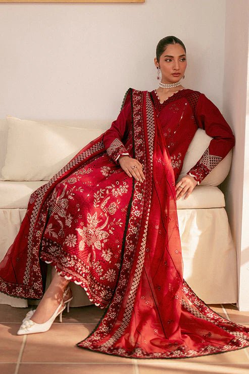 Model wearing deep red Selah dress from Saffron, showcasing Pakistani designer clothes in the UK. Ideal for festive lawn collections and readymade clothing.