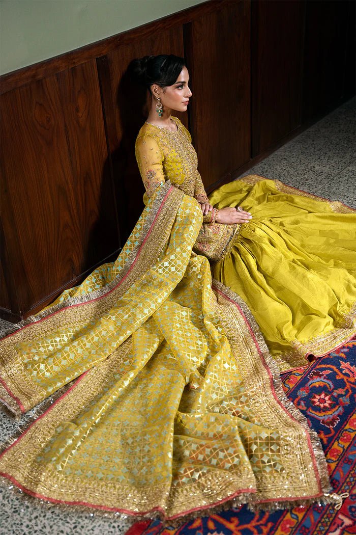 Model wearing Saira Rizwan Festive Formals '24 SERA - SRF - D - 08, a mustard yellow embellished outfit with traditional design, ideal for weddings. Available as Pakistani clothes online in the UK.