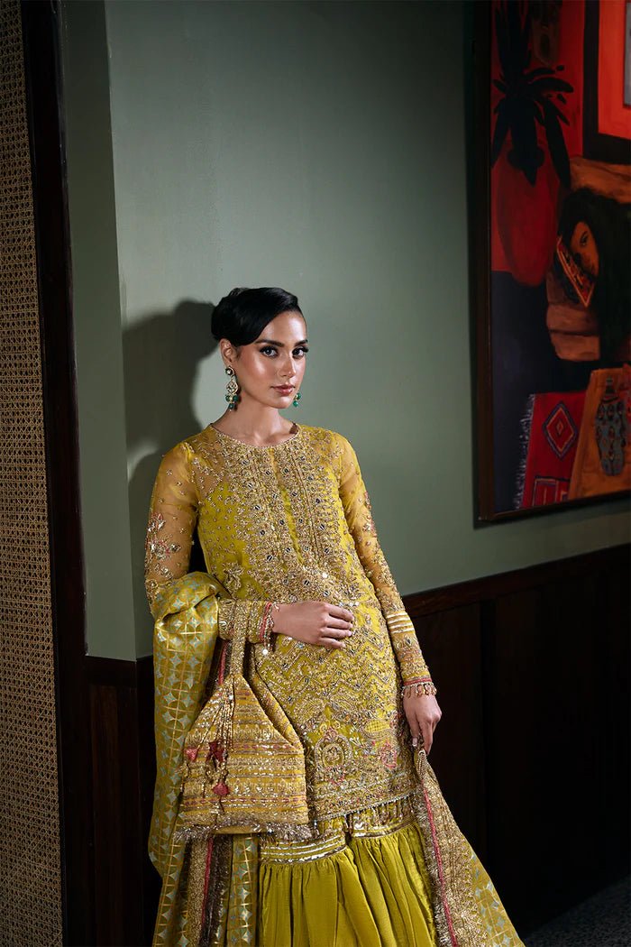 Model wearing Saira Rizwan Festive Formals '24 SERA - SRF - D - 08, a mustard yellow embellished outfit with traditional design, ideal for weddings. Available as Pakistani clothes online in the UK.