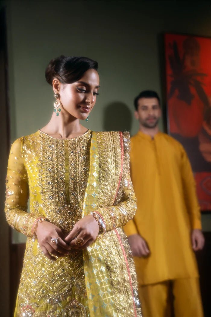 Model wearing Saira Rizwan Festive Formals '24 SERA - SRF - D - 08, a mustard yellow embellished outfit with traditional design, ideal for weddings. Available as Pakistani clothes online in the UK.