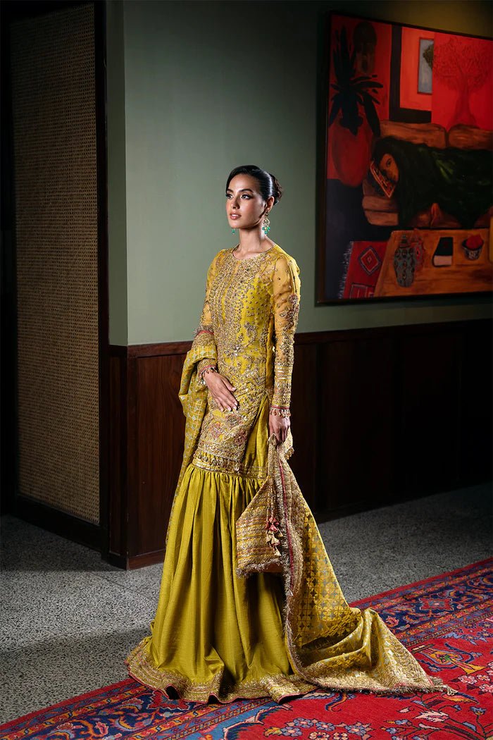 Model wearing Saira Rizwan Festive Formals '24 SERA - SRF - D - 08, a mustard yellow embellished outfit with traditional design, ideal for weddings. Available as Pakistani clothes online in the UK.