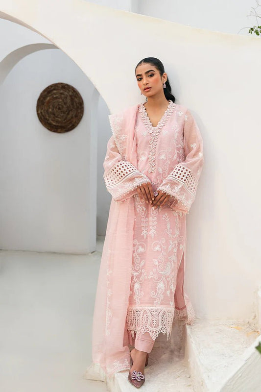 Model wearing Saira Rizwan Mirfah dress, intricate Pakistani clothes UK, elegant pink Eid attire.