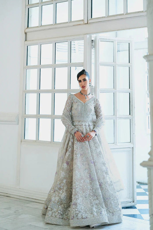 Model wearing a silver embellished dress from Saira Rizwan's Naqsh Festive '24 collection, named SRN24 - 01 DAPHNE. Perfect for wedding clothes, highlighting Pakistani clothes online in the UK.