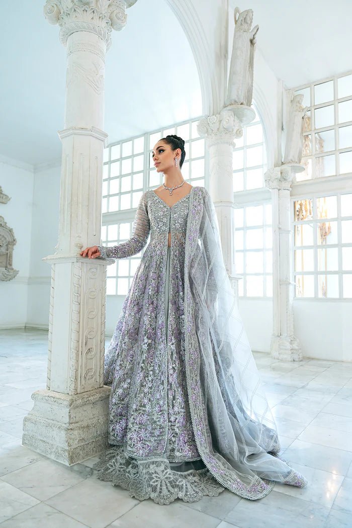 Model wearing a pastel pink and silver SRN24 - 02 ELOISE dress from Saira Rizwan. This elegant Pakistani wedding attire features intricate embroidery and luxurious fabric.