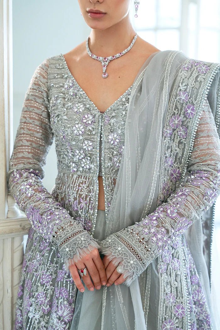 Model wearing a pastel pink and silver SRN24 - 02 ELOISE dress from Saira Rizwan. This elegant Pakistani wedding attire features intricate embroidery and luxurious fabric.