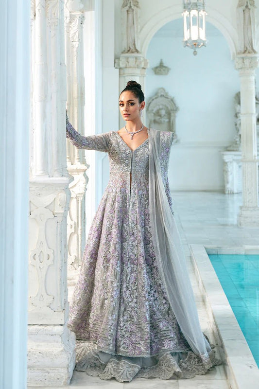 Model wearing a pastel pink and silver SRN24 - 02 ELOISE dress from Saira Rizwan. This elegant Pakistani wedding attire features intricate embroidery and luxurious fabric.