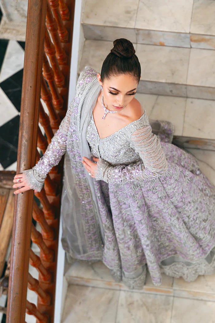 Model wearing a pastel pink and silver SRN24 - 02 ELOISE dress from Saira Rizwan. This elegant Pakistani wedding attire features intricate embroidery and luxurious fabric.