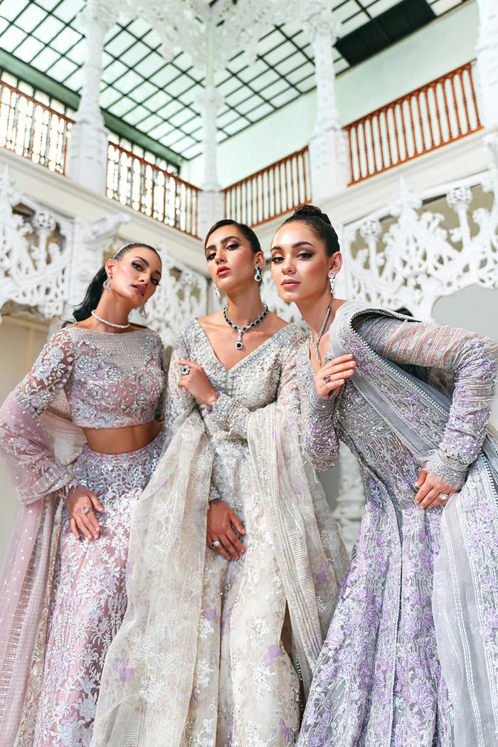 Model wearing a pastel pink and silver SRN24 - 02 ELOISE dress from Saira Rizwan. This elegant Pakistani wedding attire features intricate embroidery and luxurious fabric.