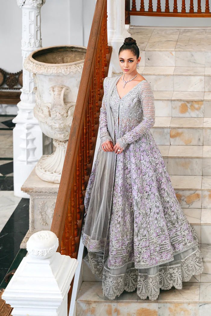 Model wearing a pastel pink and silver SRN24 - 02 ELOISE dress from Saira Rizwan. This elegant Pakistani wedding attire features intricate embroidery and luxurious fabric.