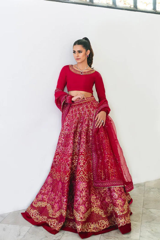 Model wearing a red SRN24 - 04 SHARMAS lehenga choli from Saira Rizwan's Naqsh Festive '24 collection. Available online in the UK, perfect for weddings.