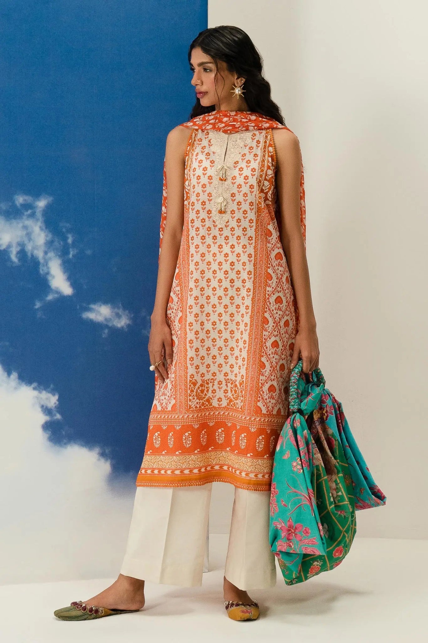 Model wearing Sana Safinaz Mahay'24 orange printed lawn suit, trendy summer dress collection in UK.