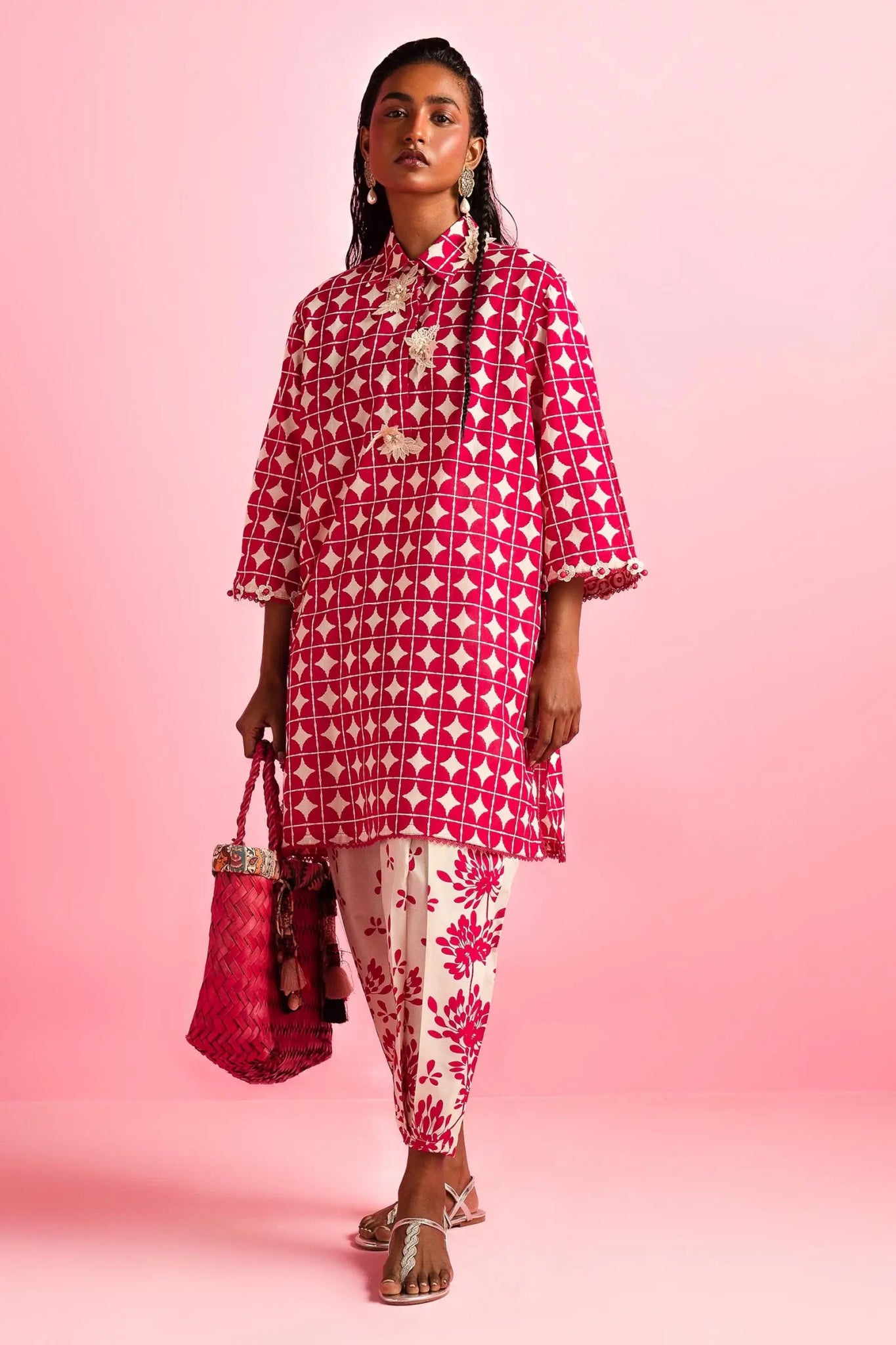 Model wearing Sana Safinaz Mahay'24 red geometric lawn dress, vibrant summer style in UK.