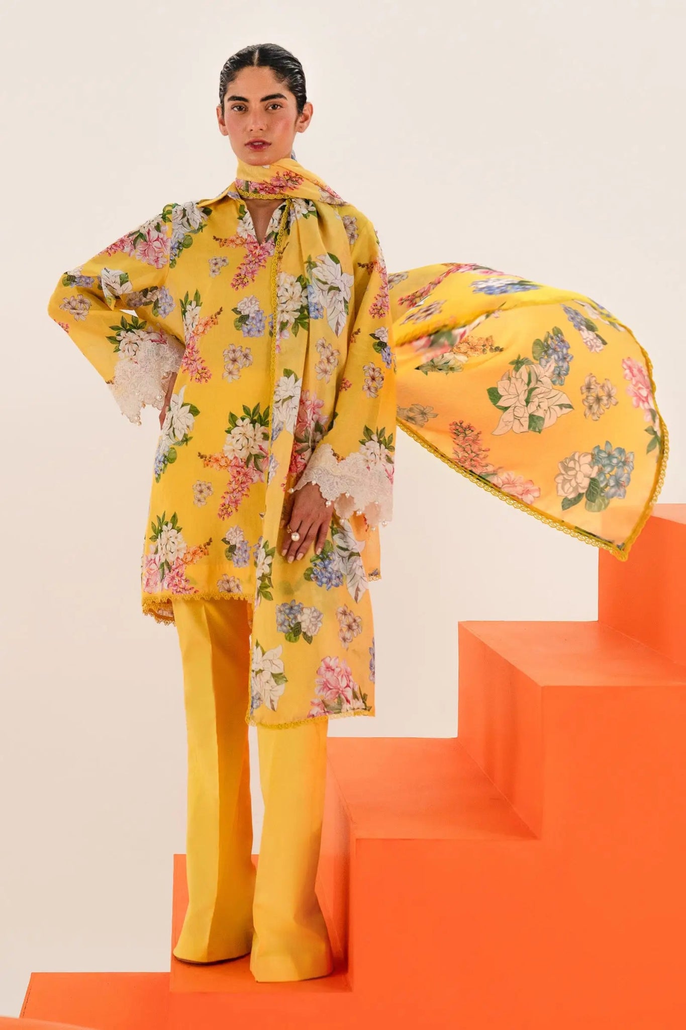 Model wearing Sana Safinaz Mahay'24 yellow floral lawn suit, bright summer outfit in UK.