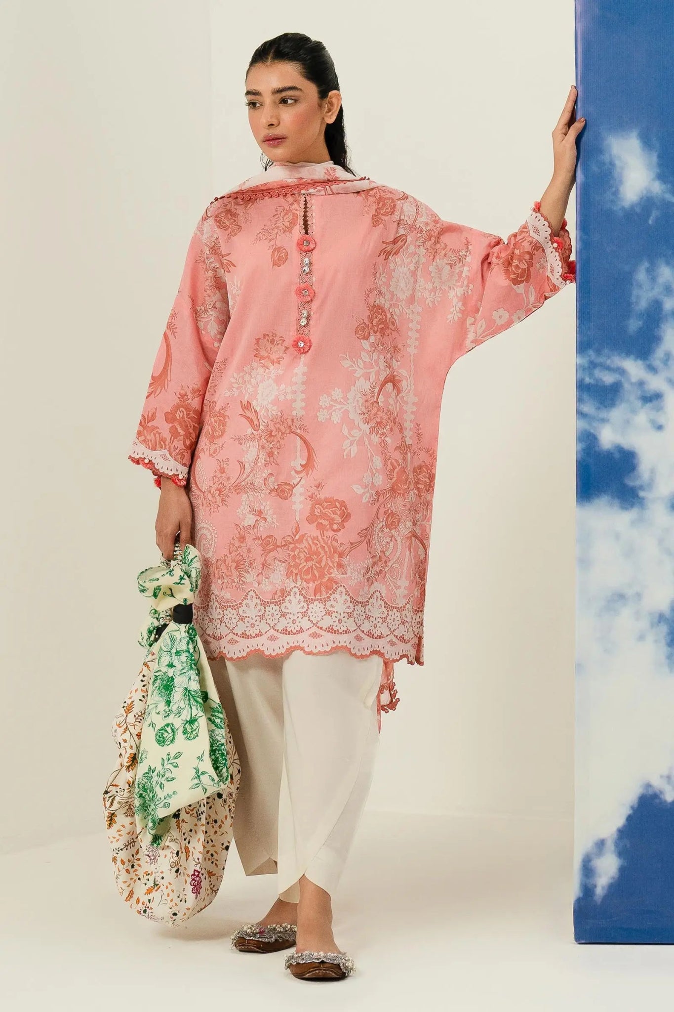 Model wearing Sana Safinaz Mahay'24 peach printed lawn dress, delicate summer design in UK.