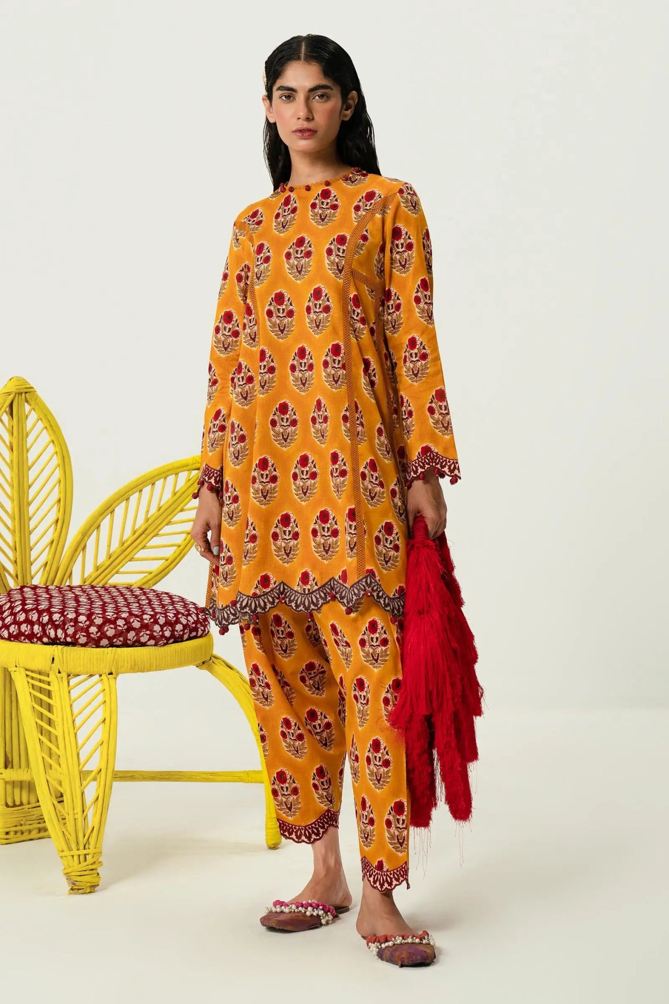 Model wearing Sana Safinaz H242 - 011A - 2AC orange Pakistani lawn suit with red dupatta.