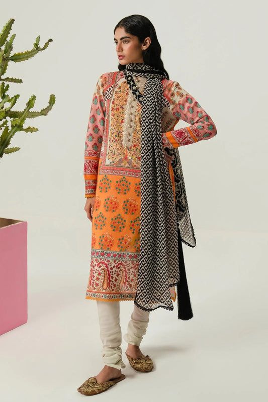 Model wearing Sana Safinaz H242 - 013B - 2I orange Pakistani lawn suit with black and white dupatta.